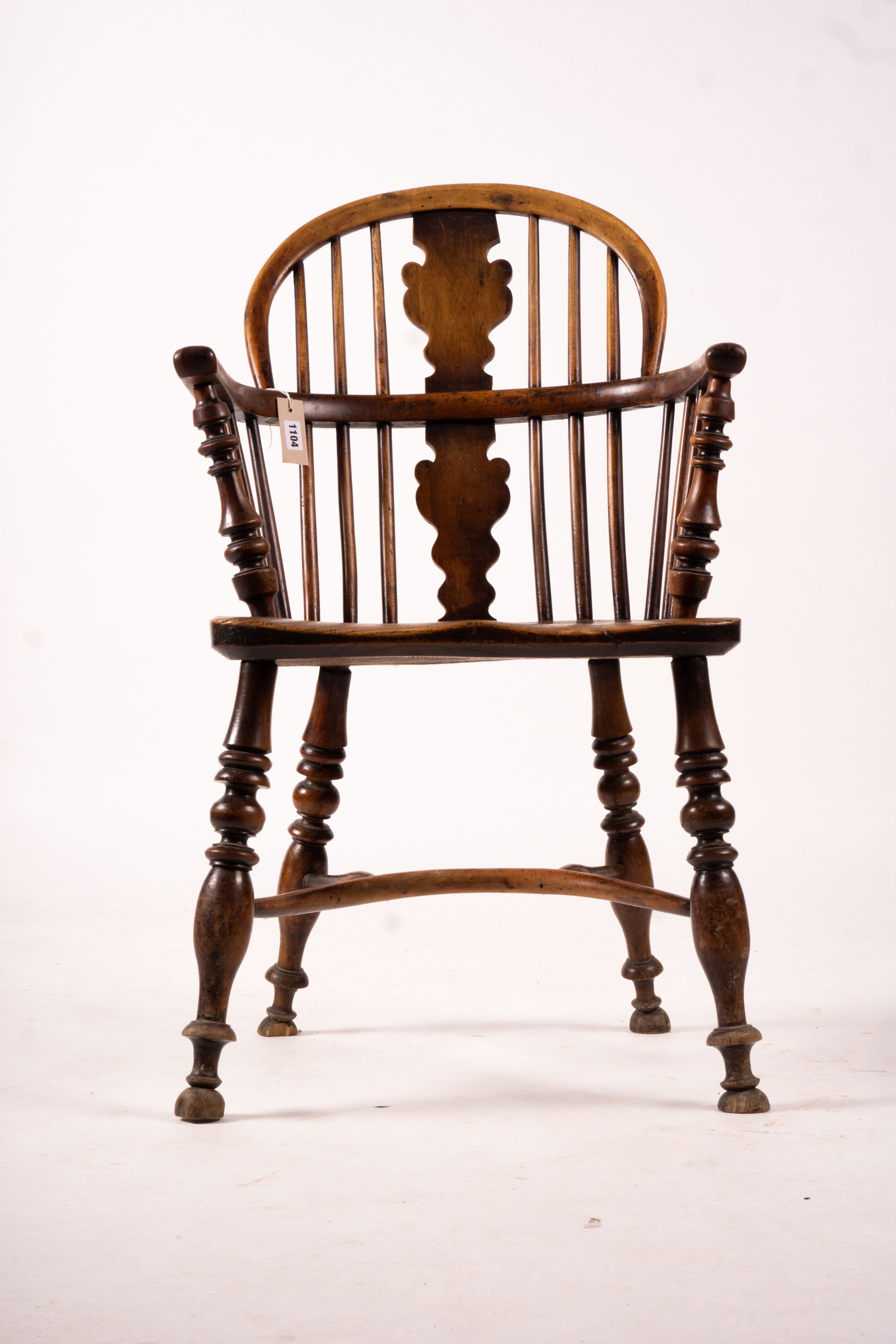 A mid 19th century yew and elm Windsor elbow chair with crinoline stretcher, width 54cm, depth 46cm, height 94cm